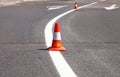 Work on road. Construction cones. Traffic cone, with white and orange stripes on asphalt. Street and traffic signs for signaling. Royalty Free Stock Photo