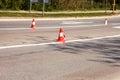 Work on road. Construction cones. Traffic cone, with white and orange stripes on asphalt. Street and traffic signs for signaling. Royalty Free Stock Photo