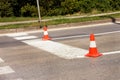 Work on road. Construction cones. Traffic cone, with white and orange stripes on asphalt. Street and traffic signs for signaling. Royalty Free Stock Photo