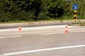 Work on road. Construction cones with traffic sign keep right sign. Traffic cones, with white and orange stripes on asphalt. Royalty Free Stock Photo