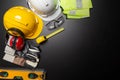 Work safety. Construction site protective equipment on wooden background, flat lay, copy space, top view Royalty Free Stock Photo