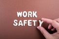 Work Safety. White wooden letters with words on a brown background Royalty Free Stock Photo