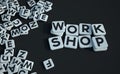 Work shop written in letter tiles black background