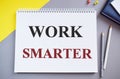 Work smart, text motivational reminder handwritten written in Notebook