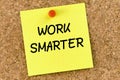 Work Smarter PostIt Note Pinned To Cork Board
