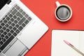 work space with laptop note book ball pen and coffee on red background. flat lay Royalty Free Stock Photo