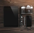Work space for photographer. Flat lay of digital tablet, camera, phone, glasses, pencil on wooden table Royalty Free Stock Photo