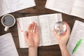 Work stress concept. Hands holding pills and glass of water above Workspace desk Royalty Free Stock Photo