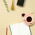 Work and study place. note book, cup of coffee, smart phone with floral decoration Royalty Free Stock Photo