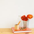 Work and study place. note book, pencil with floral decoration on wooden desk with white background Royalty Free Stock Photo