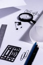 Work table of an architect with blank paper, magnifying glass, ruler, pencils, pens and clips. Architect ready to start work. In b Royalty Free Stock Photo