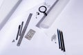 Work table of an architect with blank paper, magnifying glass, ruler, pencils, pens and clips. Architect ready to start work. In b Royalty Free Stock Photo