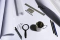 Work table of an architect with blank paper, magnifying glass, ruler, pencils, pens and clips. Architect ready to start work. In b Royalty Free Stock Photo