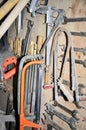 Work table of a carpenter with many tools olds hanging Royalty Free Stock Photo