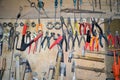 Work table of a carpenter with many tools olds hanging Royalty Free Stock Photo