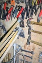 Work table of a carpenter with many tools olds hanging Royalty Free Stock Photo