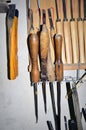 Work table of a carpenter with many tools olds hanging Royalty Free Stock Photo