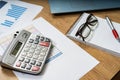 Work table at home with pen, papers, bills, charts, glasses, computer and calculator. Concept work at home, checking accounts,