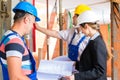 Work Team on construction site controlling floor plan Royalty Free Stock Photo