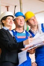 Work Team on construction site controlling floor plan Royalty Free Stock Photo