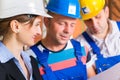 Work Team on construction site controlling floor plan Royalty Free Stock Photo