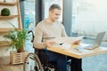 Alert disabled man working in a cafe