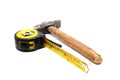 Work tool series: Old tape measure and hammer Royalty Free Stock Photo