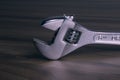 Work tools, adjustable hand wrench, on a wooden table