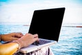 Asian women businessmen are working with laptop computer by the sea in the summer. Royalty Free Stock Photo