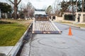 Work truck with tilting bed with machinery loaded and swirling track on pavement where a machine made sharp turn in upscale