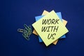 Work with us symbol. Yellow steaky note with words Work with us. Beautiful deep blue background. Business and Work with us concept