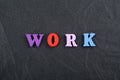 WORK word on black board background composed from colorful abc alphabet block wooden letters, copy space for ad text. Learning Royalty Free Stock Photo