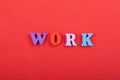 WORK word on red background composed from colorful abc alphabet block wooden letters, copy space for ad text. Learning english Royalty Free Stock Photo