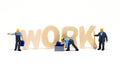 Work word wooden letters and worker models on white background. Blue collar work concept scene. Royalty Free Stock Photo