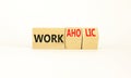 Work or workaholic symbol. Concept words Work or Workaholic on wooden cubes. Beautiful white table white background. Businessman