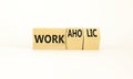 Work or workaholic symbol. Concept words Work or Workaholic on wooden cubes. Beautiful white table white background. Businessman