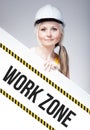 Work zone sign placed on information board, worker woman