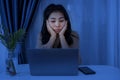 Workaholic business Asian woman working late at night feeling sleepy and tired sitting at desk with laptop Royalty Free Stock Photo