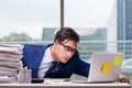 Workaholic businessman overworked with too much work in office