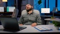 Workaholic businessman slepping on chair in business company office late at night