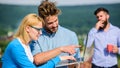 Workaholics concept. Colleagues with laptop work outdoor sunny day, nature background. Couple works despite of coffee