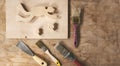 Workbench or desk carpenter with trowel, wood billets and brushes, art crafts diver and fish made from wood, copy space