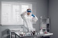 Workbench of a research laboratory where a scientist puts a drop of reagent pipetting into a test tube