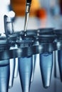 Detail of a Laboratory pipette with drop over tubes rack Royalty Free Stock Photo