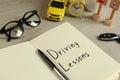 Workbook for driving lessons with pen on wooden table, closeup. Passing license exam Royalty Free Stock Photo