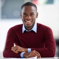 The workday is going better than ever. Portrait of a smiling young businessman sitting at a desk in an office. Royalty Free Stock Photo