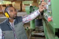 Worker adjusting the machine Royalty Free Stock Photo