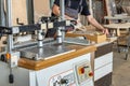 Operator setting up multi-spindle drilling machine for furniture panel processing Royalty Free Stock Photo
