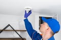 A worker adjusts the extractor hood in the bathroom