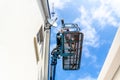 Worker on a aerial access platform, cherry picker, cleaning house